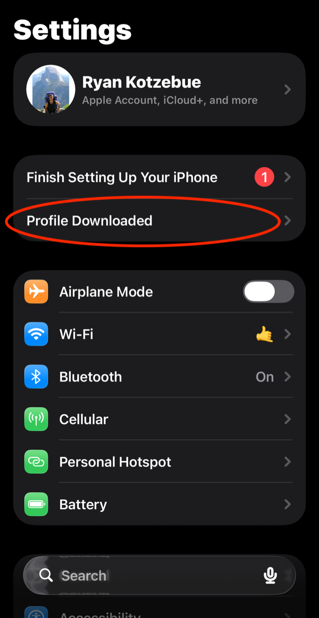 iOS Settings home screen with the Profile Downloaded row circled near the top.